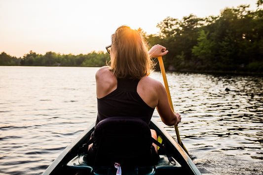 Owner and artist Celina Johnson paddling a canoe in the Kawartha Highlands